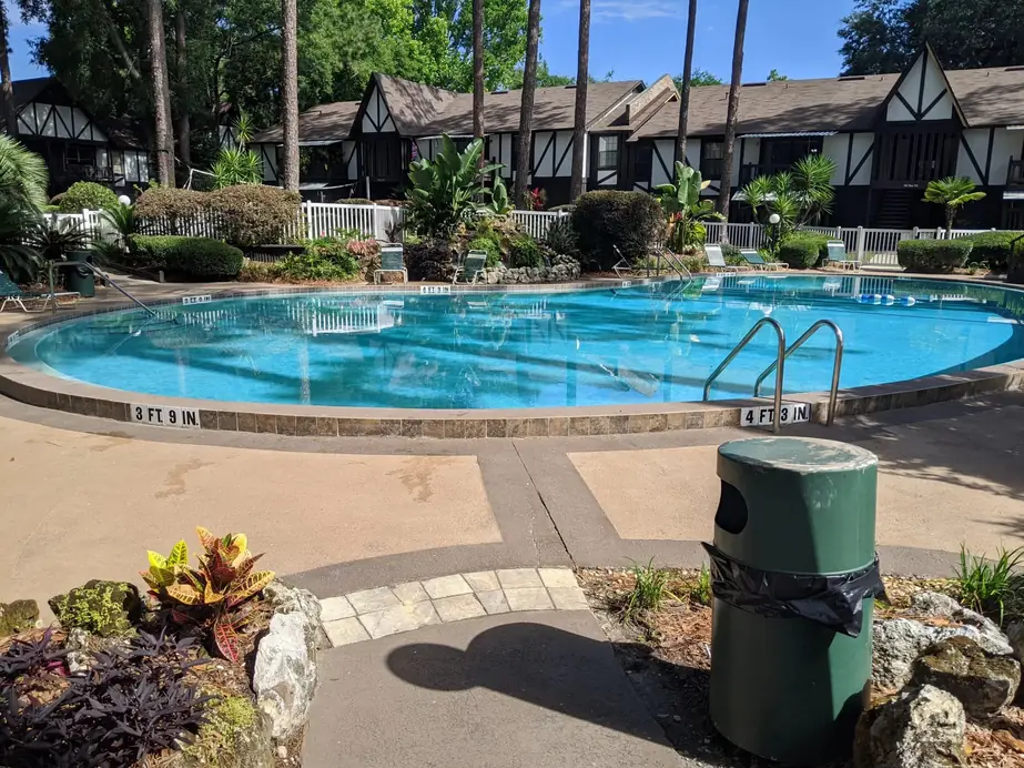 Apartment complex pool at Piccadilly Apartments in Gainesville, FL with depth markers on the coping